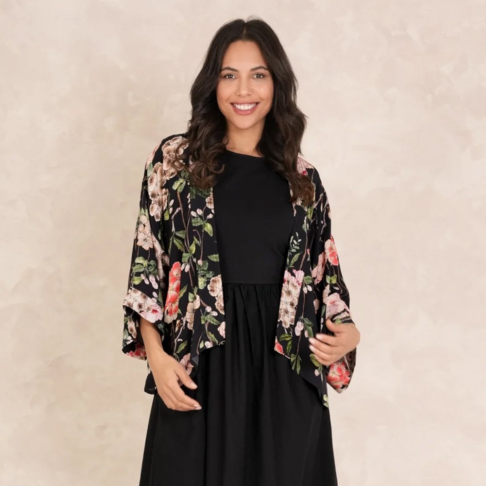 Are kimonos comfortable​? Woman wearing a black One Hundred stars kimono with a black dress. 