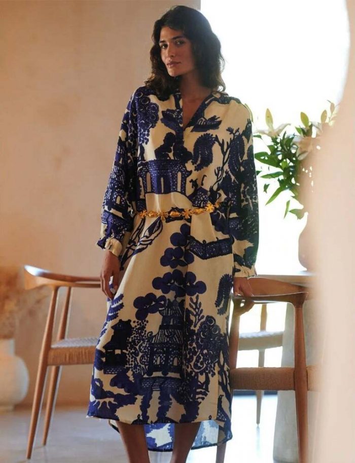 How to style a kimono dress​. Woman wearing a blue and white One Hundred Stars kimono dress with a gold belt. 