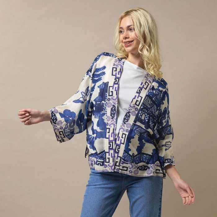 How to style a kimono for casual everyday wear. Woman wearing a blue One Hundred Stars Kimono with a white T-shirt and jeans.