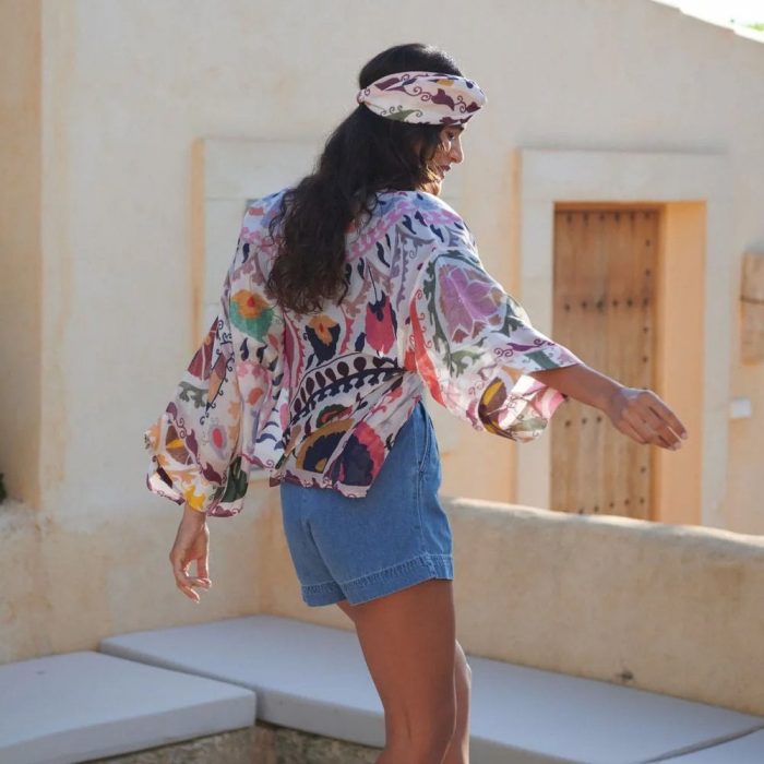 How to style a kimono for casual holiday wear. Woman wearing a multi-coloured One Hundred Stars kimono and matching headband.