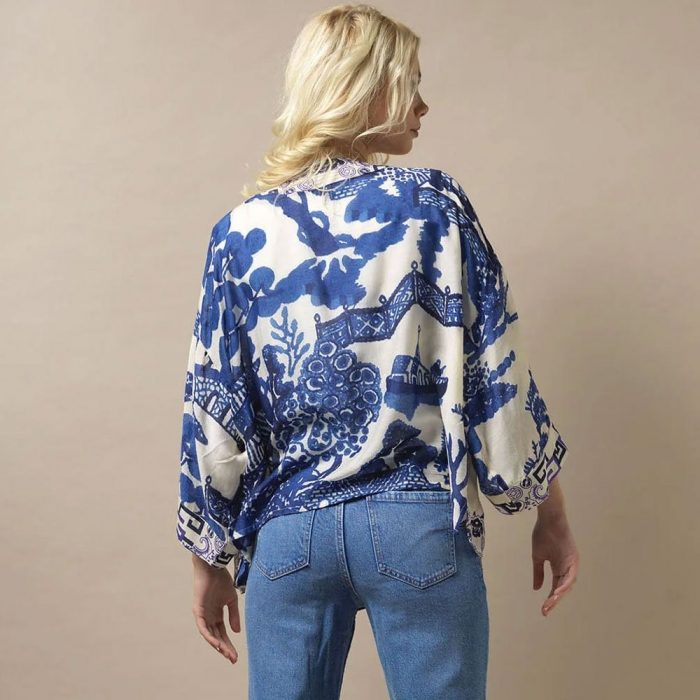 How to style a kimono with jeans. Woman wearing a blue One Hundred Stars Kimono with jeans.