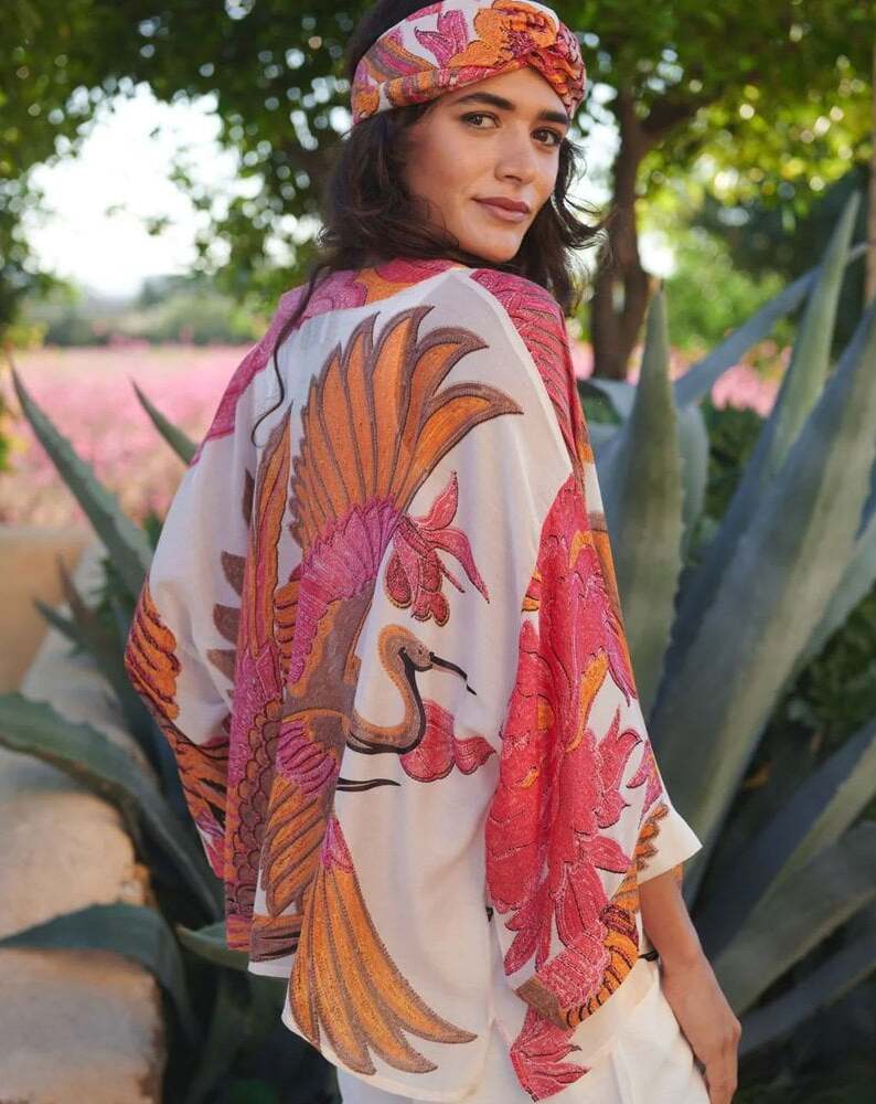 How to style a kimono. Woman wearing a pink and orange One Hundred Stars Kimono and headband. 