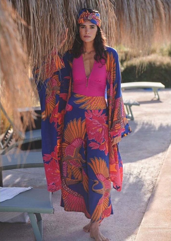 How to style a long kimono​. Woman wearing a blue, pink and orange One Hundred Stars long kimono throwover with matching palazzo pants and headband