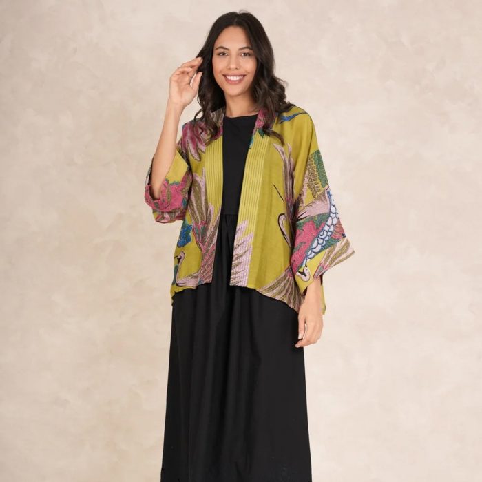 How to style a short kimono​. Woman wearing a short yellow One Hundred Stars kimono with a black dress. 