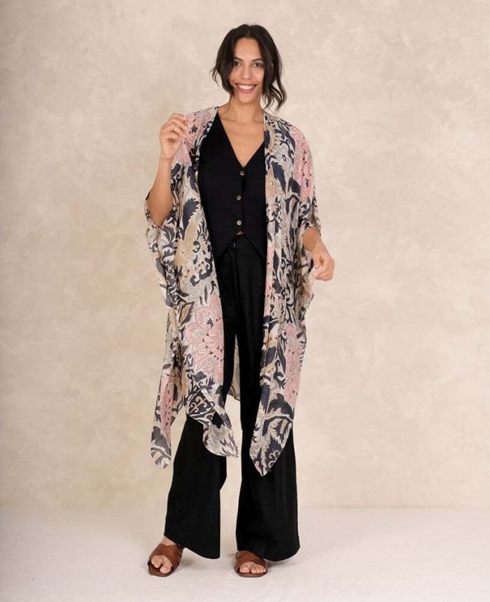 What shoes to wear with a kimono​. Woman wearing a pink One Hundred Stars kimono throwover with brown slip-on mules.